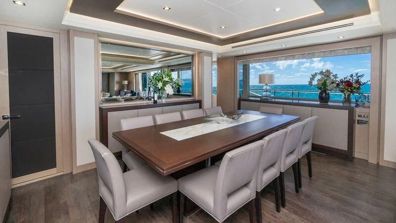a room with a table and chairs aboard SUNSET Yacht for Sale