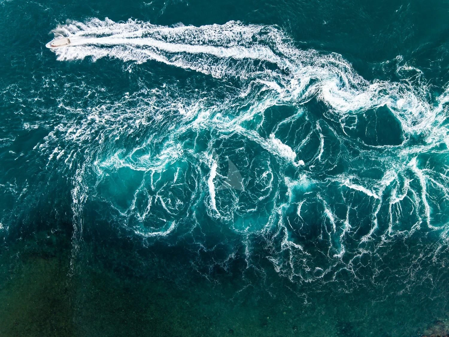 a wave crashing on the shore aboard SUNSET Yacht for Sale