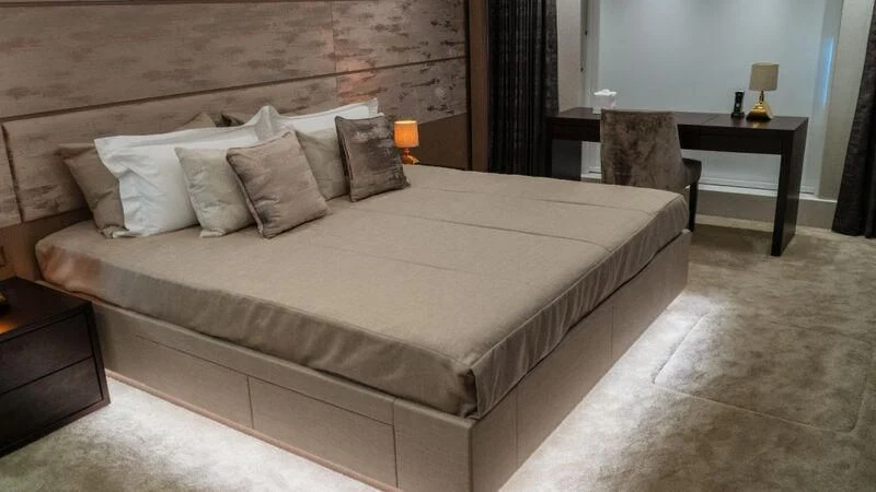 a bed with a white comforter aboard SUNSET Yacht for Sale