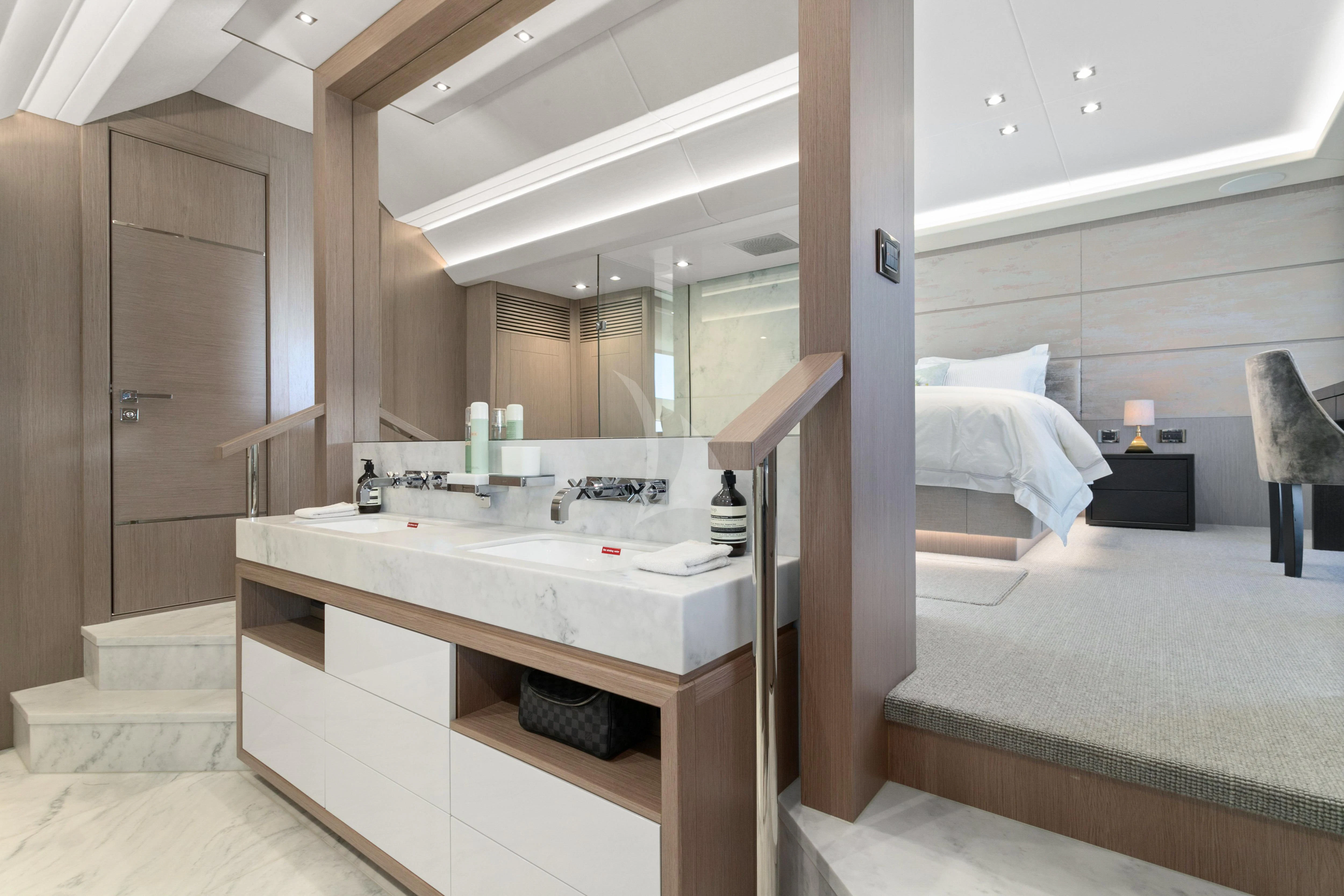 a bathroom with a sink and a bed aboard SUNSET Yacht for Sale