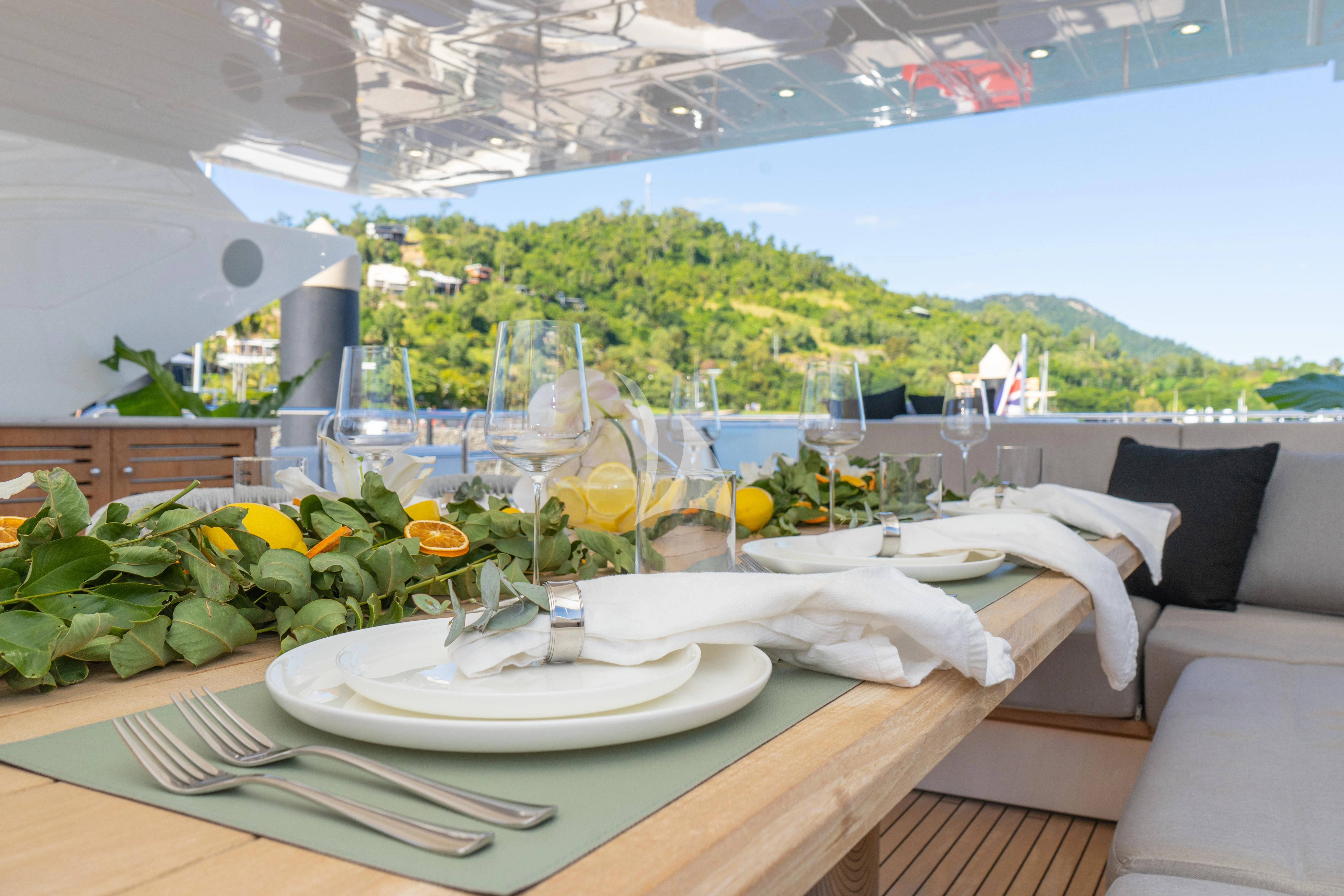 a table with plates and glasses on it aboard SUNSET Yacht for Sale