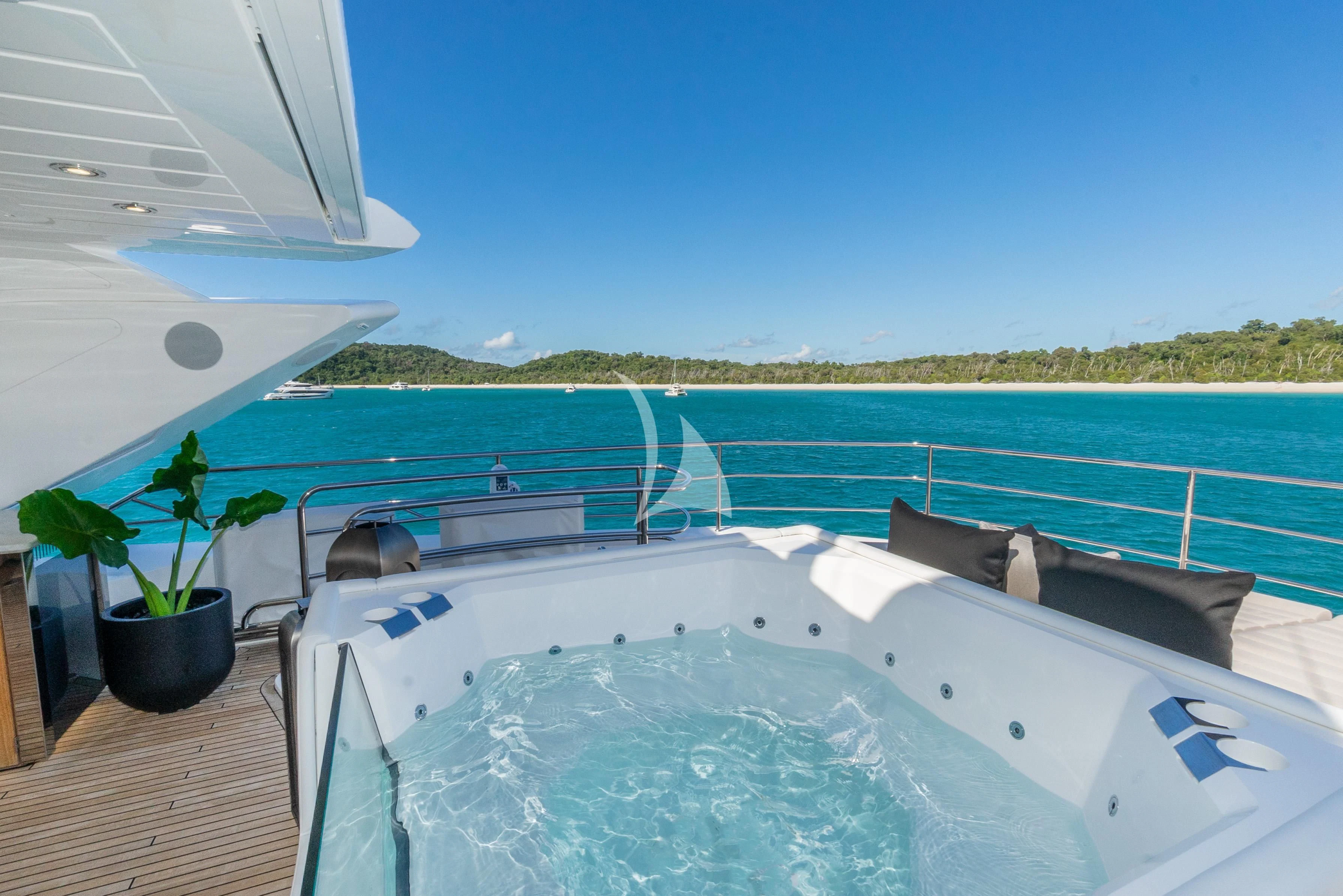 a large white boat on a blue water body aboard SUNSET Yacht for Sale