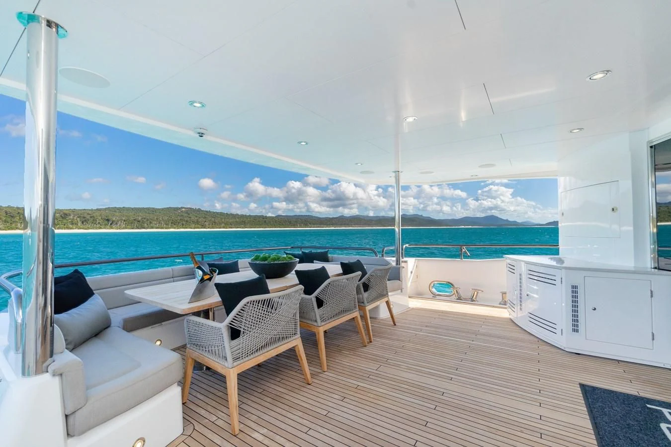 a deck with chairs and a table aboard SUNSET Yacht for Sale