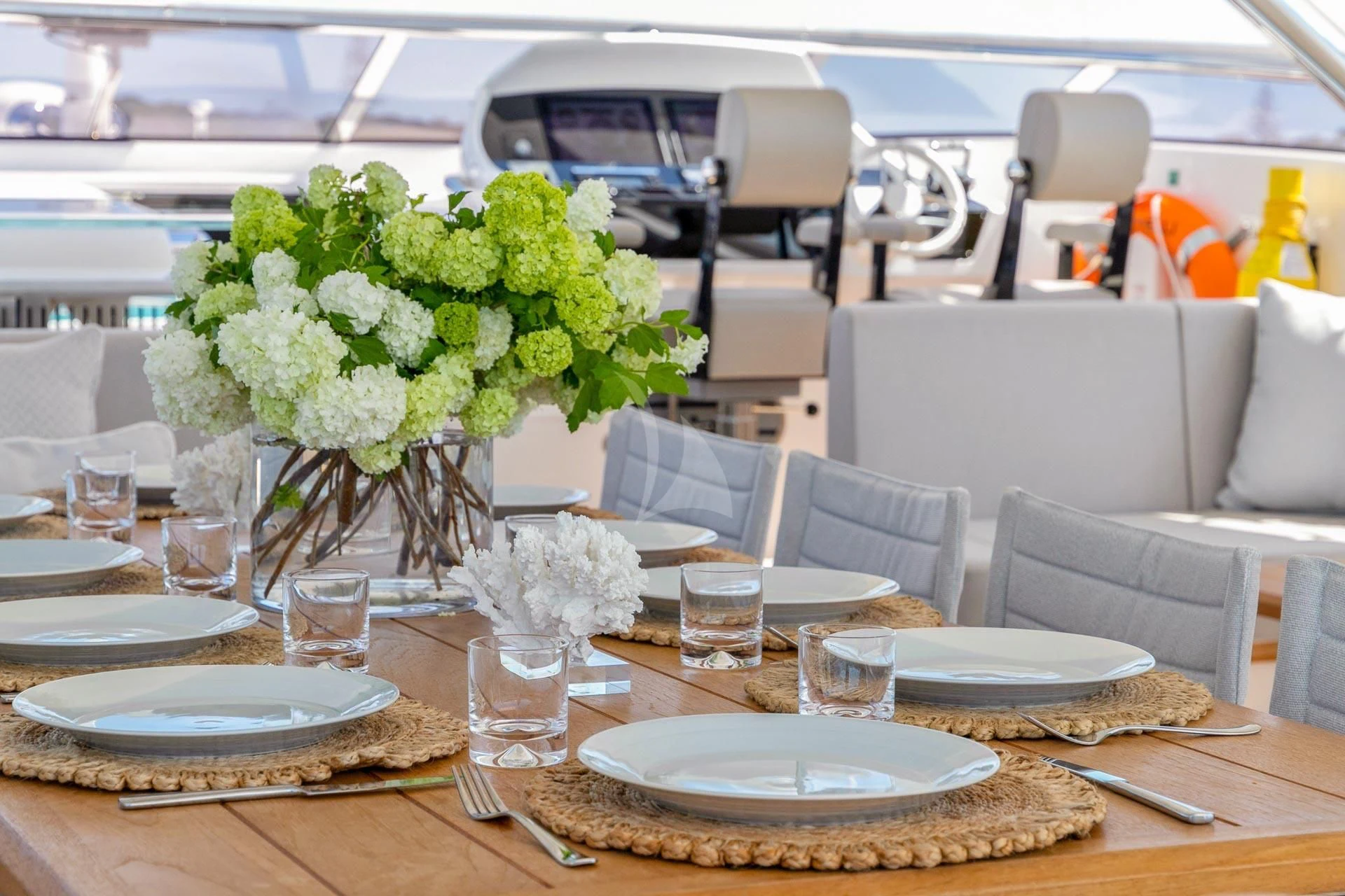 a table set with plates and glasses aboard SUNSET Yacht for Sale