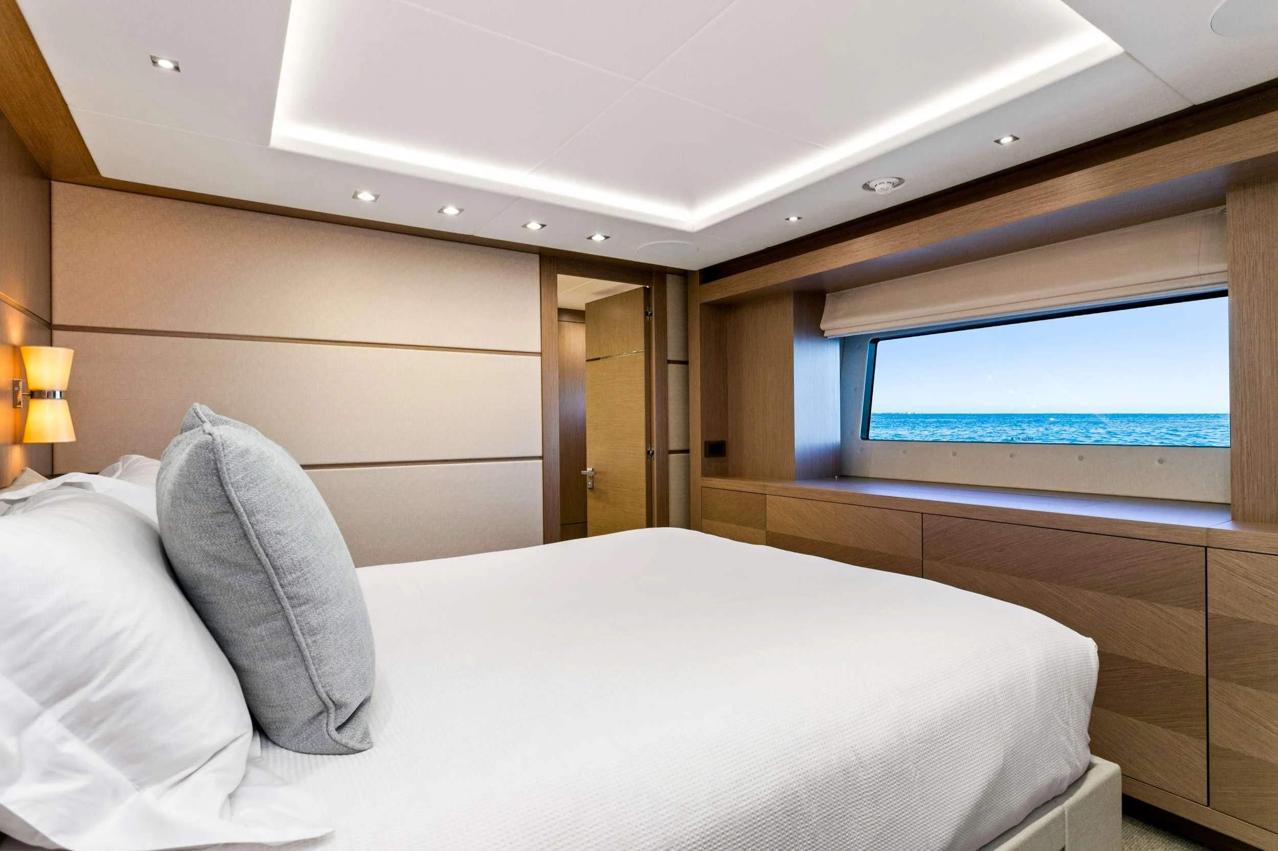 a bed with a white bed spread aboard SUNSET Yacht for Sale