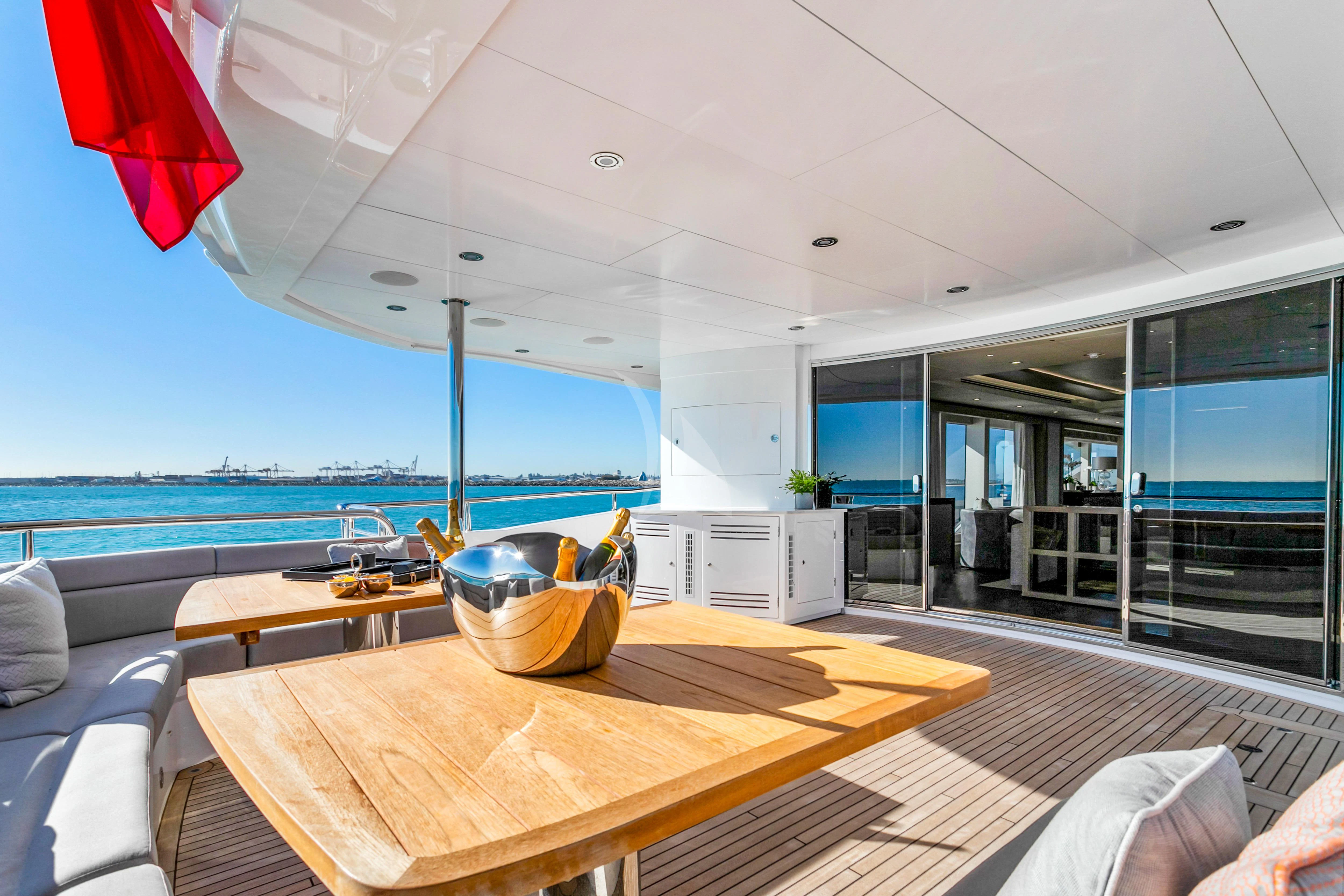a large open kitchen with a wood table and white chairs aboard SUNSET Yacht for Sale