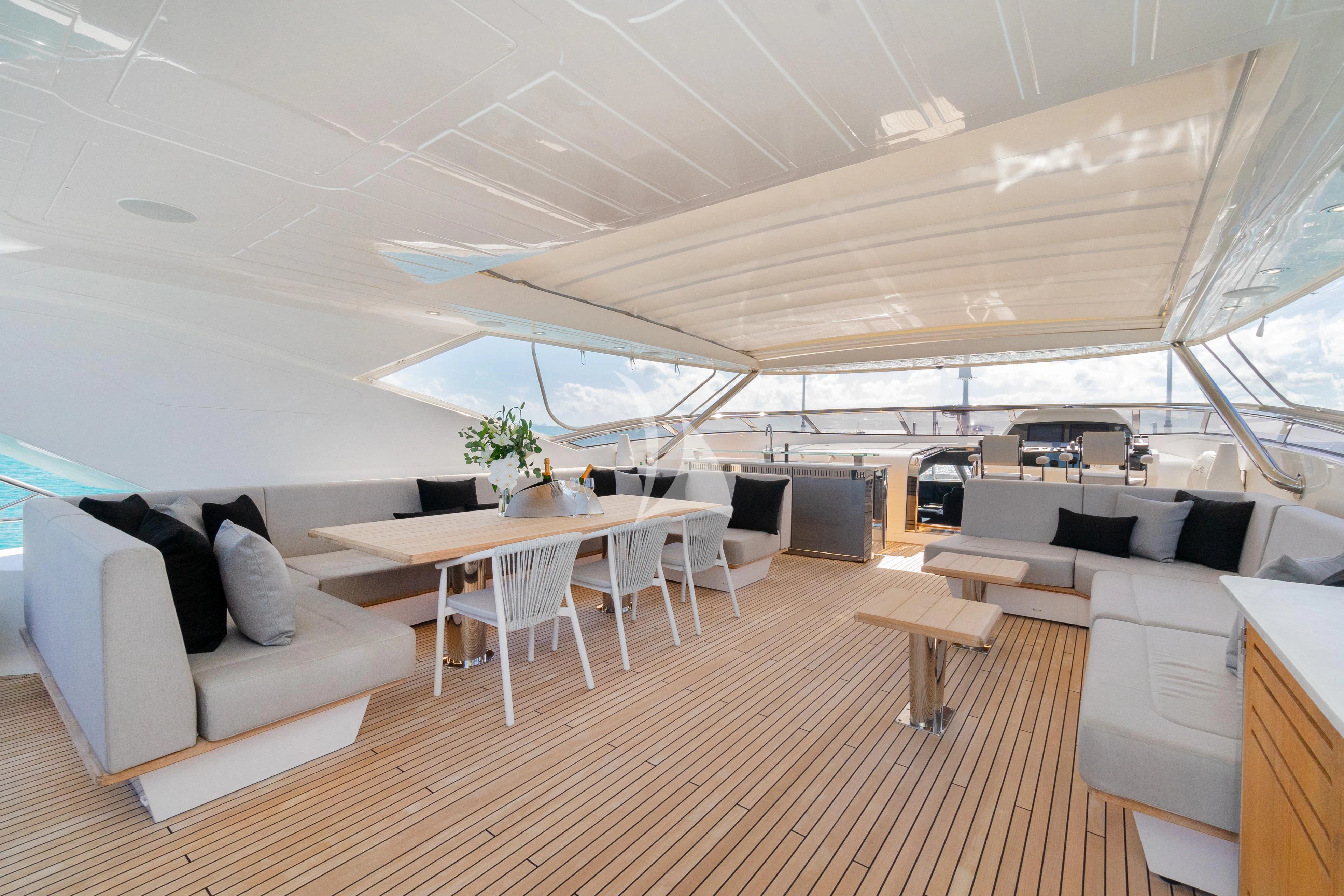 a room with a couch and a table and chairs aboard SUNSET Yacht for Sale