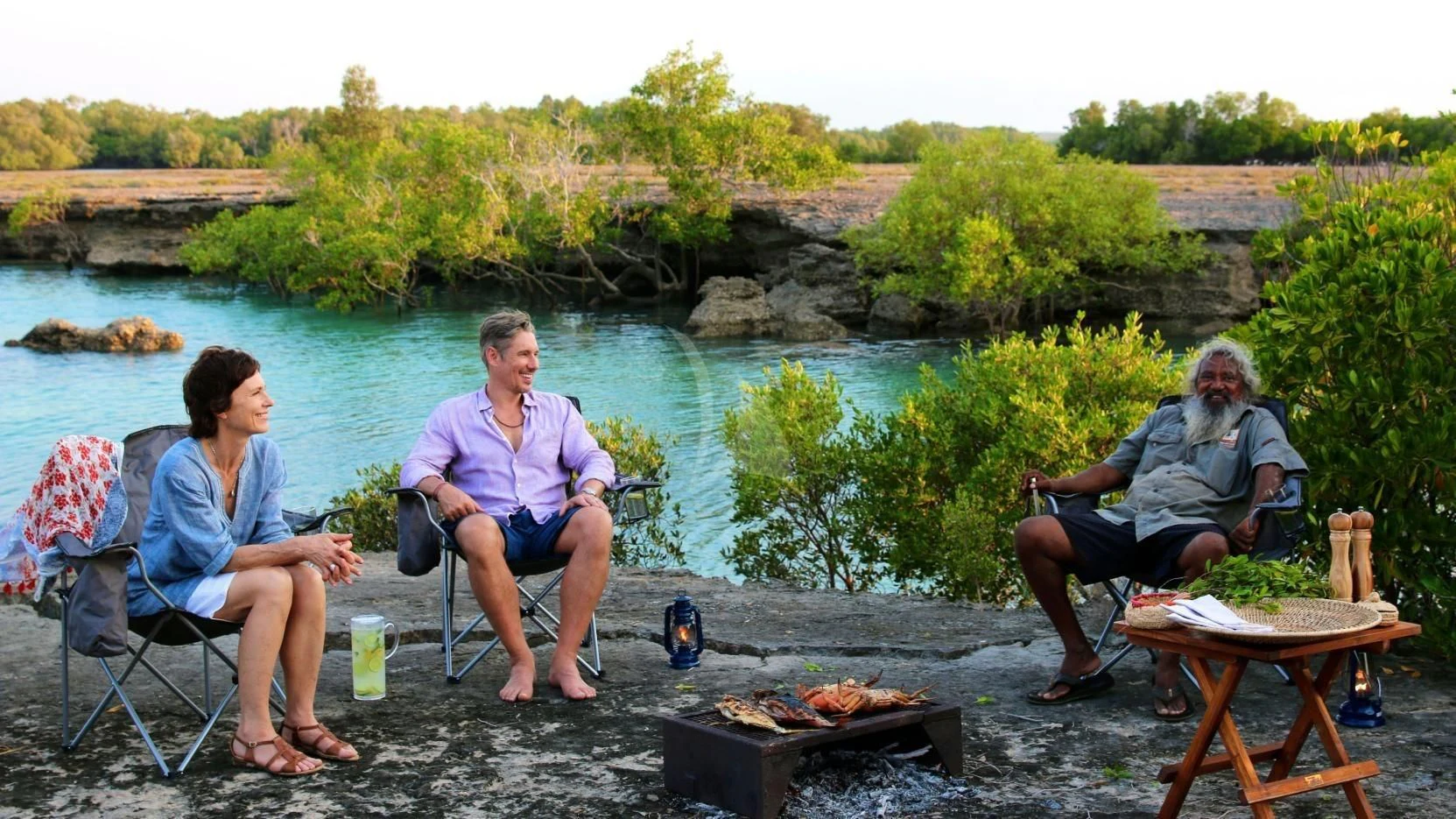 a group of people sitting around a fire pit aboard SUNSET Yacht for Sale