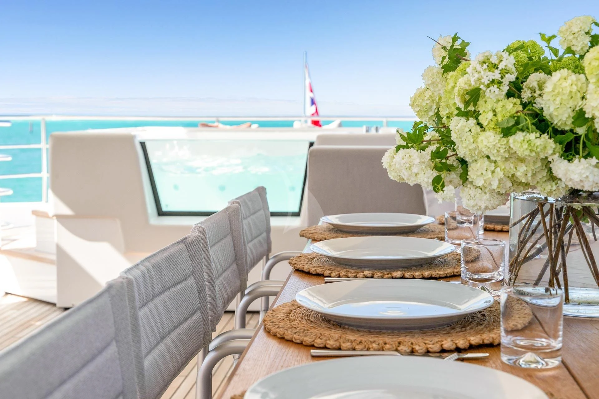 a table set with plates and glasses aboard SUNSET Yacht for Sale