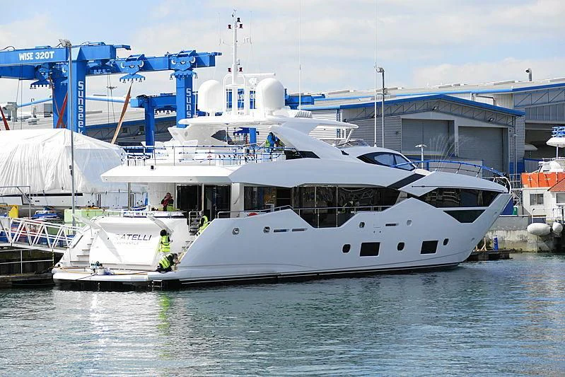 a large white boat in a harbor aboard SUNSET Yacht for Sale