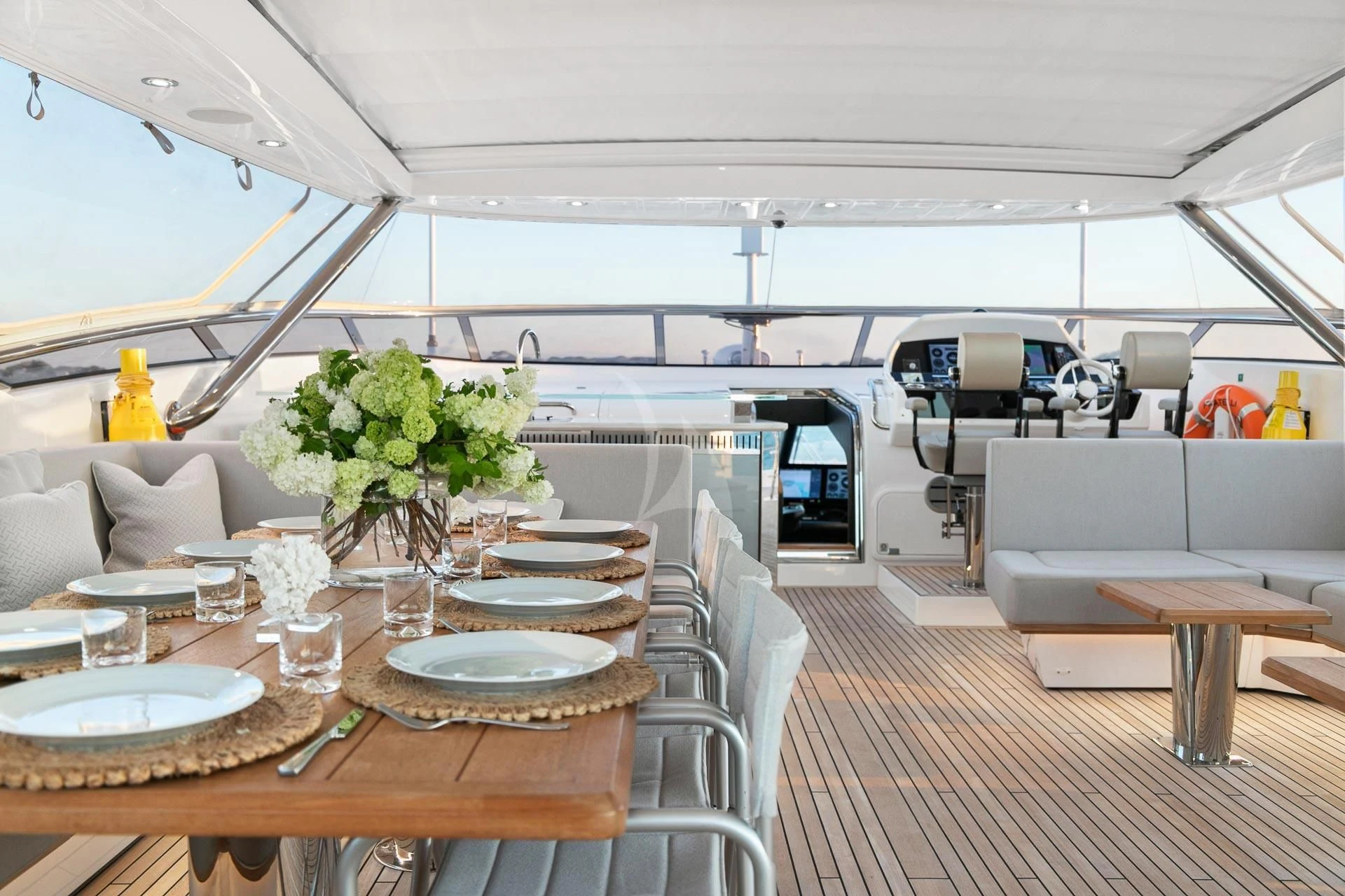 a large room with a table and chairs aboard SUNSET Yacht for Sale