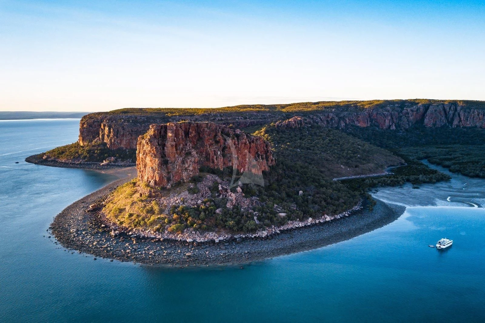 a large rock formation on a beach aboard SUNSET Yacht for Sale