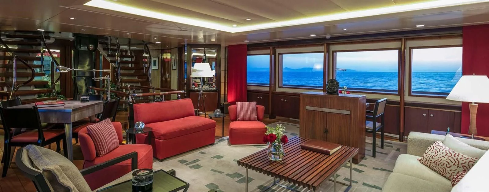 a living room with red furniture aboard PEGASUS Yacht for Charter