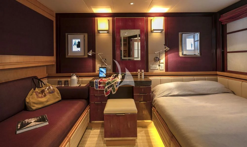 a room with a bed and a mirror aboard PEGASUS Yacht for Charter