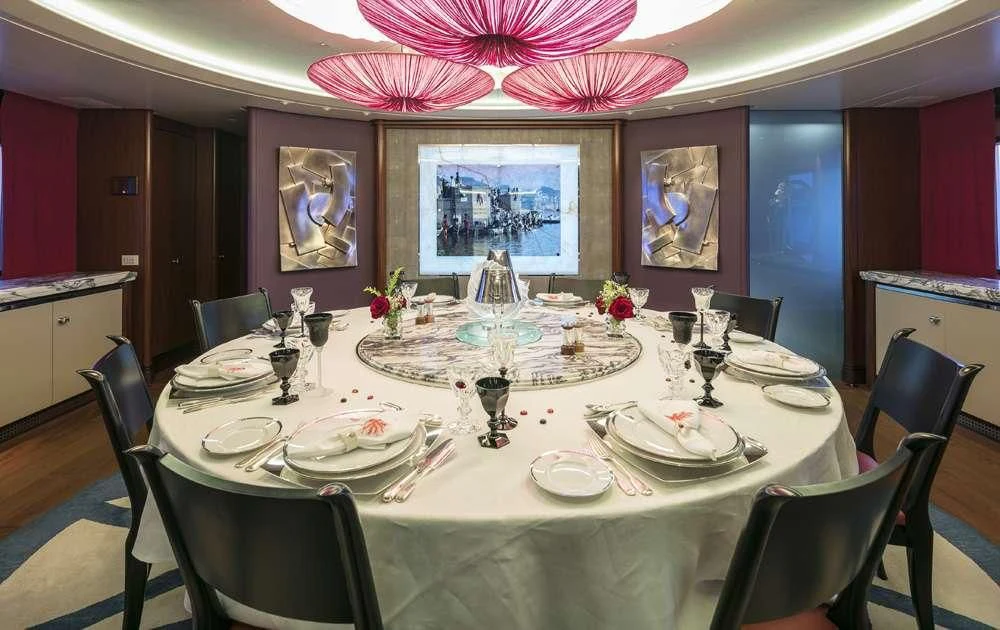 a dining room table set for a dinner party aboard PEGASUS Yacht for Charter