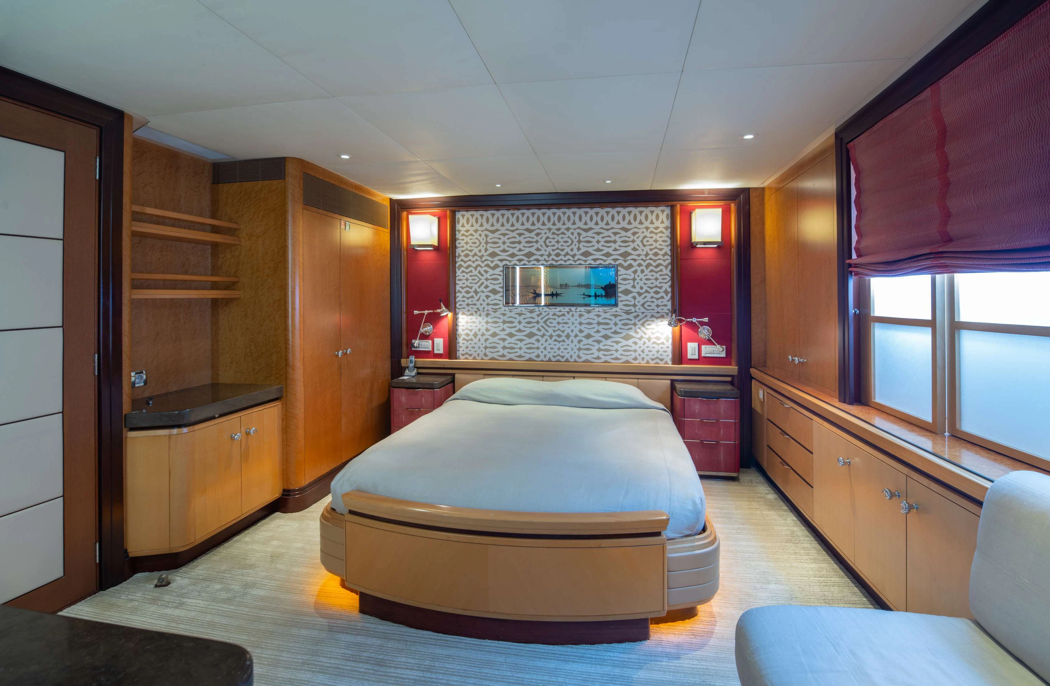 a bedroom with a bed and a desk aboard PEGASUS Yacht for Charter