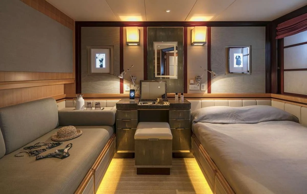 a room with a bed and a desk aboard PEGASUS Yacht for Charter