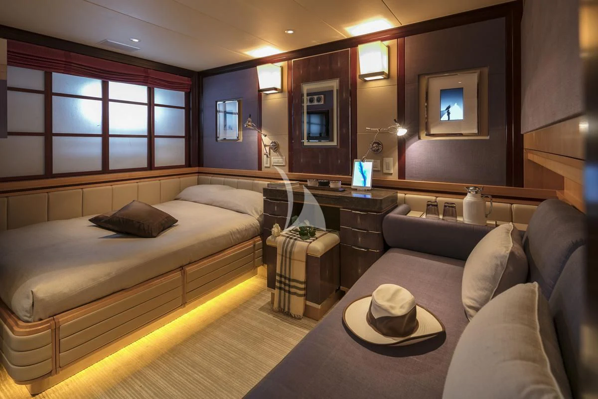 a room with a bed and a couch aboard PEGASUS Yacht for Charter
