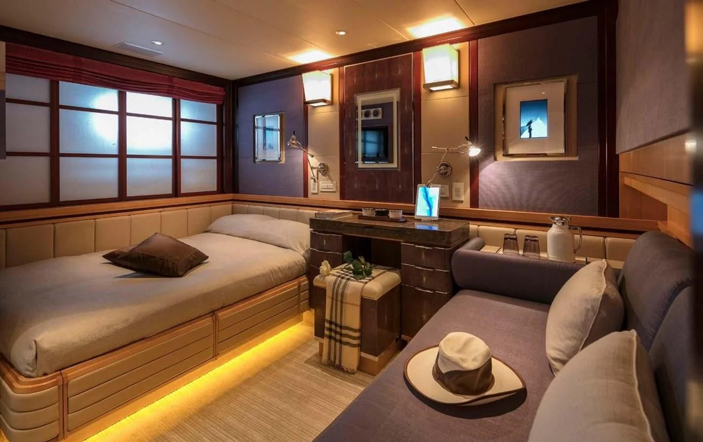 a room with a bed and a couch aboard PEGASUS Yacht for Charter