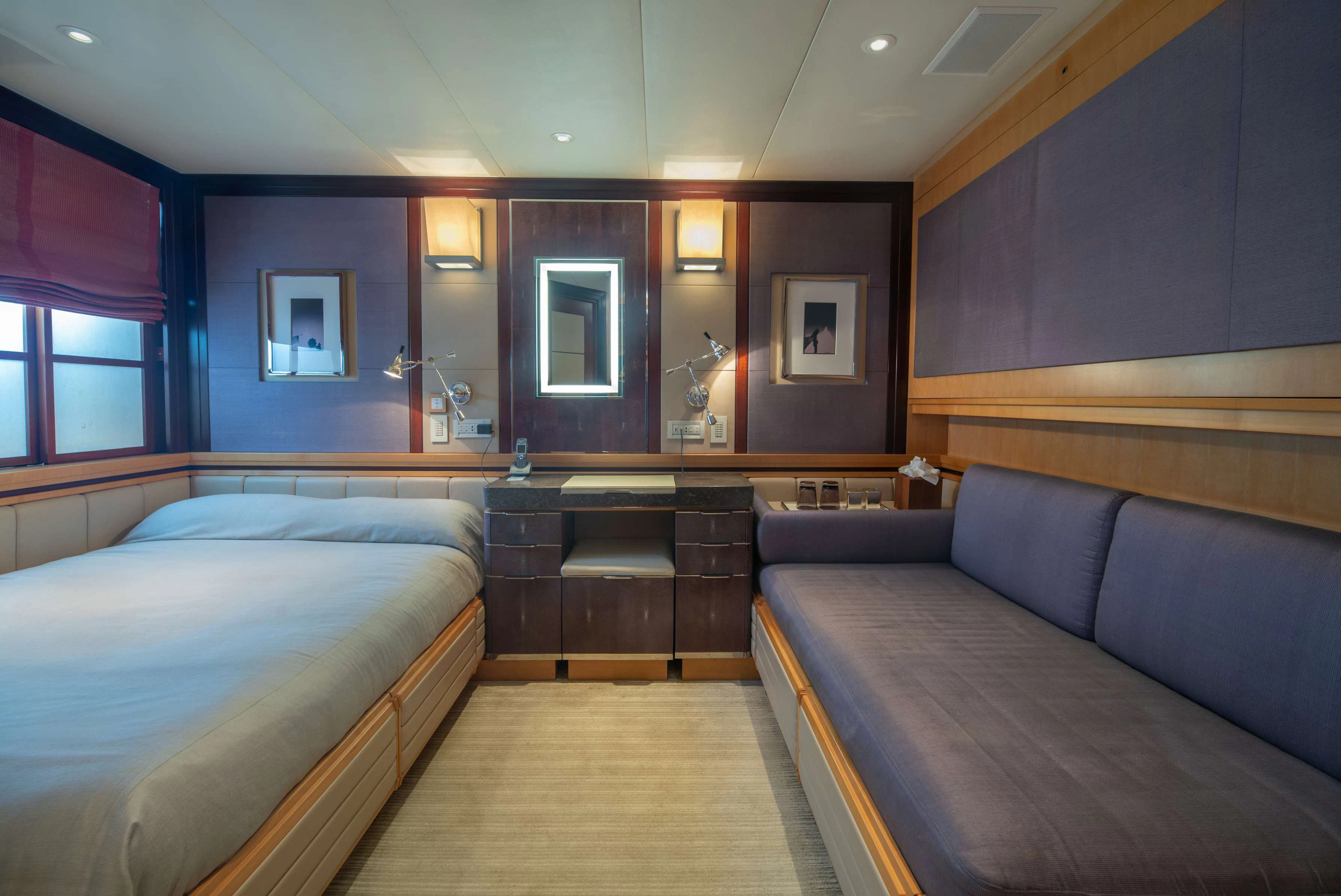 a room with a bed and a couch aboard PEGASUS Yacht for Charter