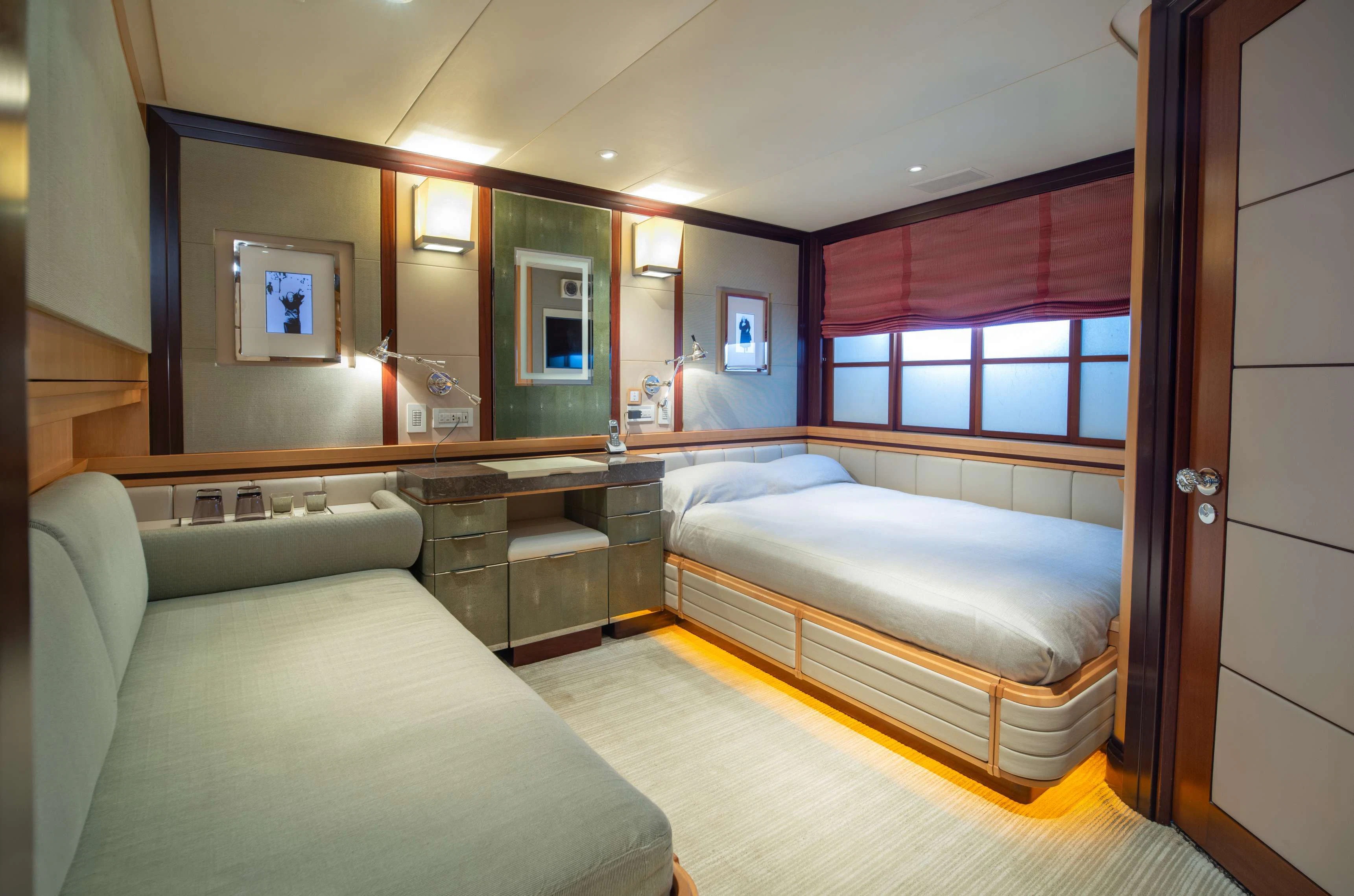 a room with a bed and a desk aboard PEGASUS Yacht for Charter