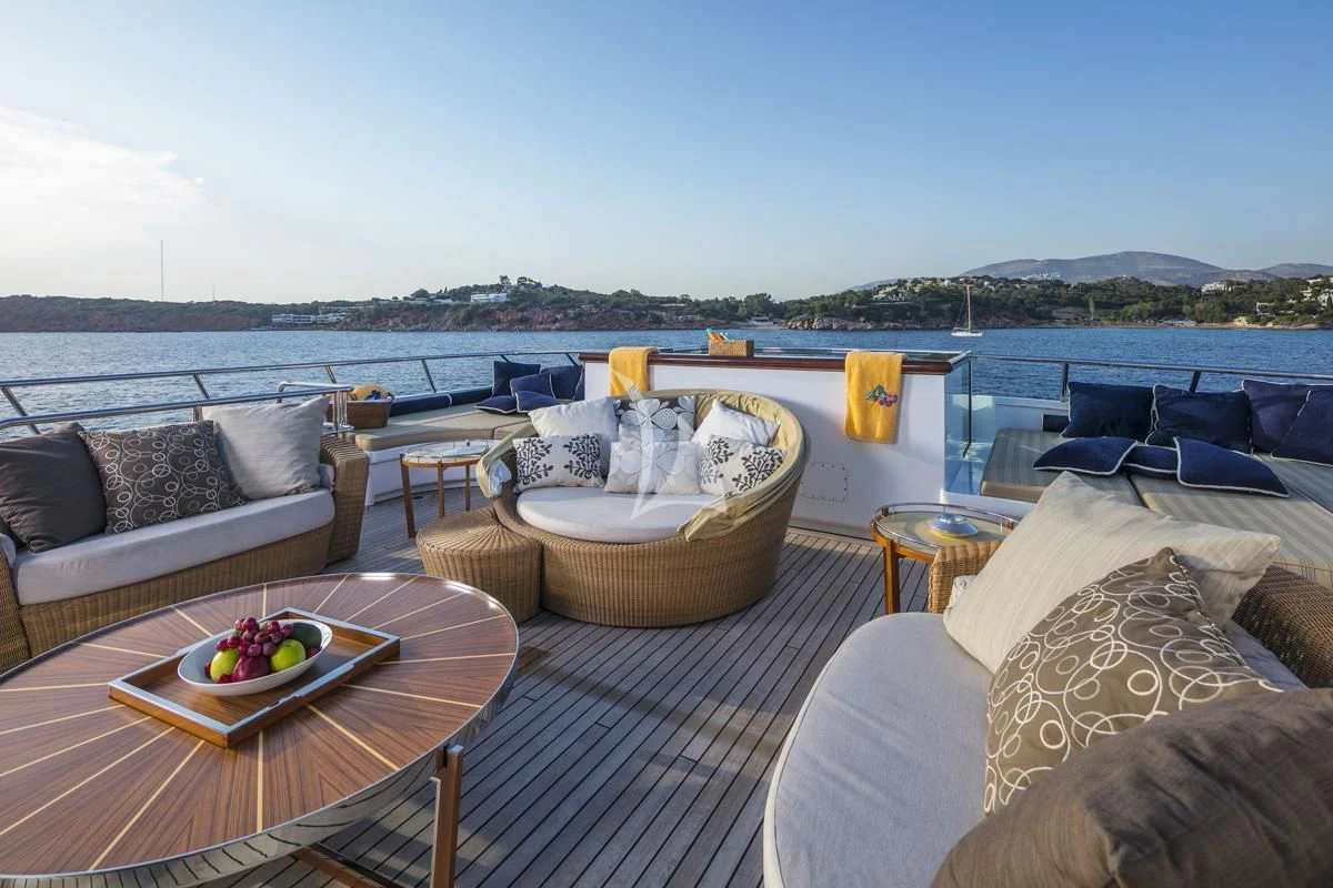 a large patio with a table and chairs on it aboard PEGASUS Yacht for Charter