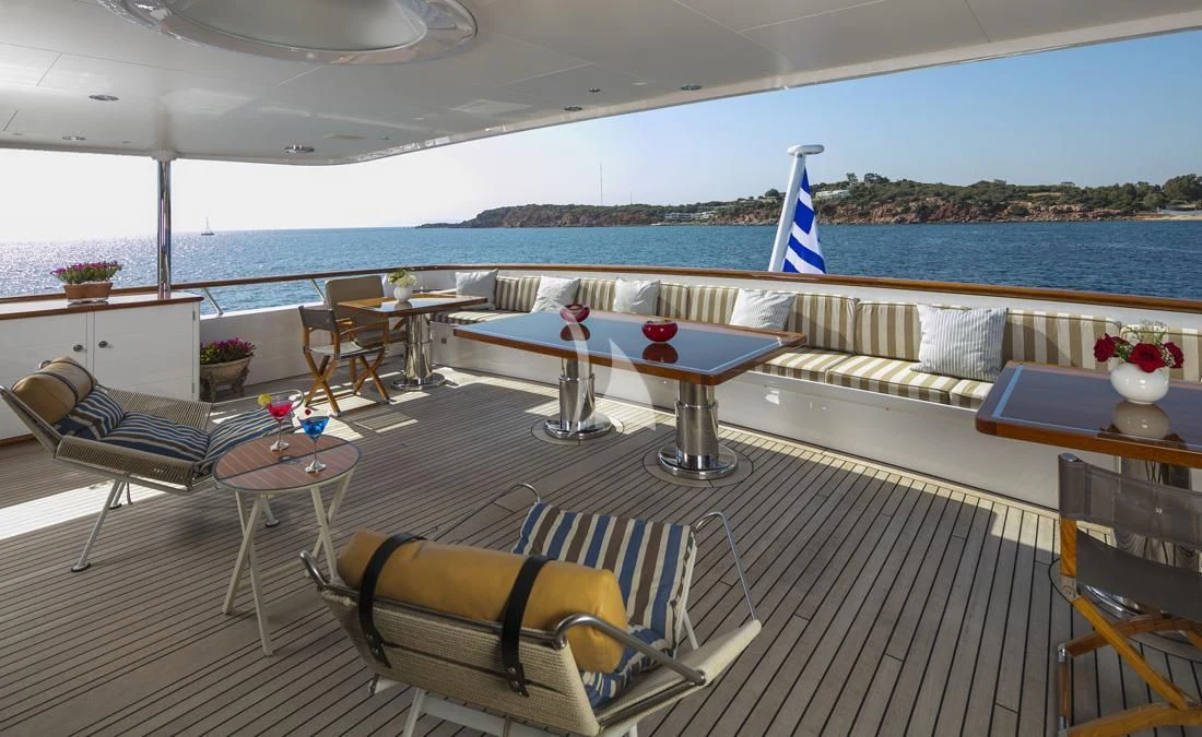 a room with a table chairs and a large body of water aboard PEGASUS Yacht for Charter
