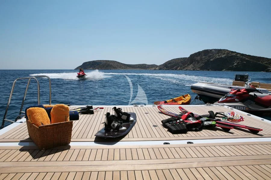a picnic table with a basket and a couple of boats on it aboard PEGASUS Yacht for Charter