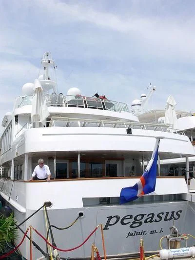 a white boat with flags on it aboard PEGASUS Yacht for Charter