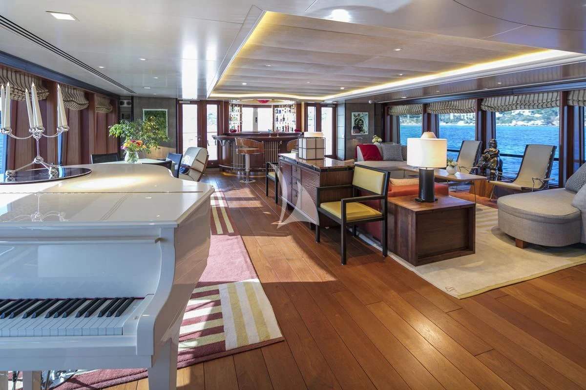 a room with a large window and a table with chairs and a large window aboard PEGASUS Yacht for Charter
