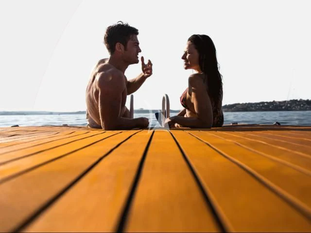 a man and woman sitting on a boat aboard PEGASUS Yacht for Charter
