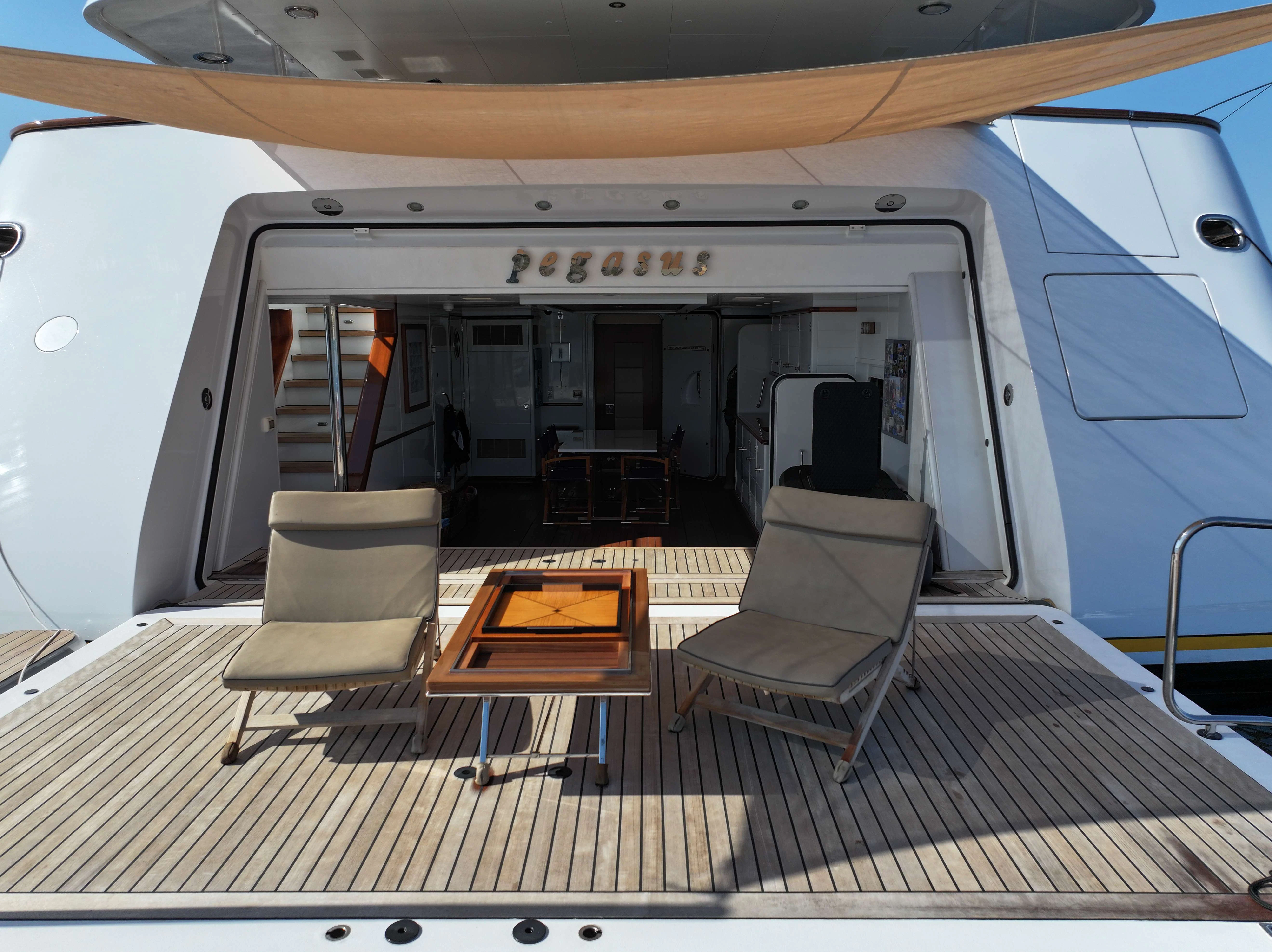 a train with chairs and a table aboard PEGASUS Yacht for Charter