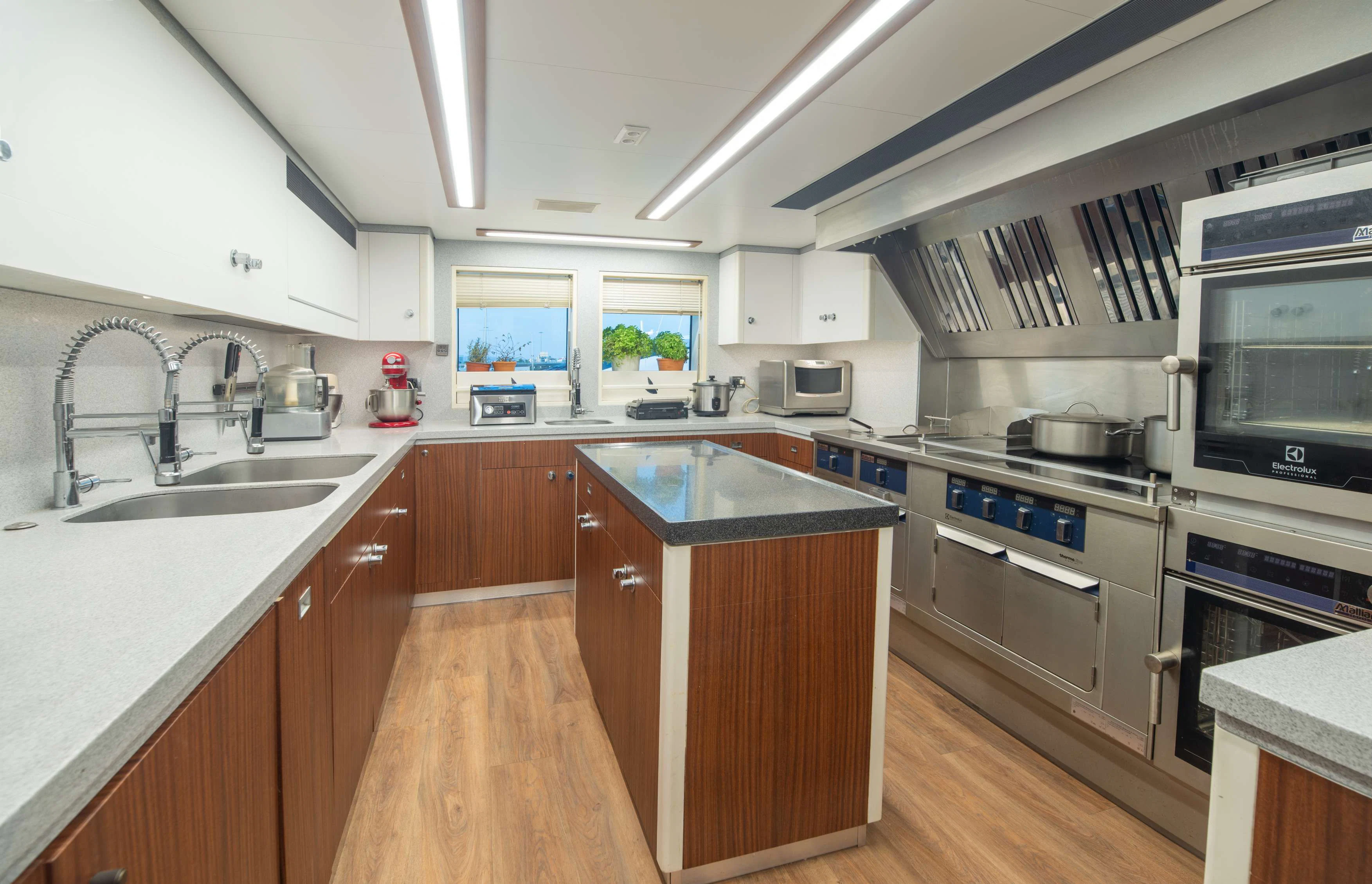 a kitchen with a large island aboard PEGASUS Yacht for Charter