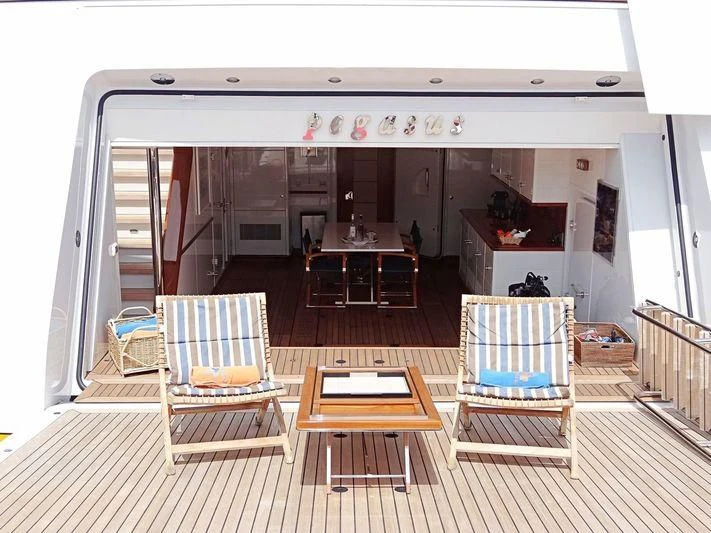a room with a table chairs and a bench aboard PEGASUS Yacht for Charter