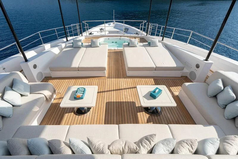 a deck with a pool and a deck with chairs and a boat aboard ELIZABETH Yacht for Sale