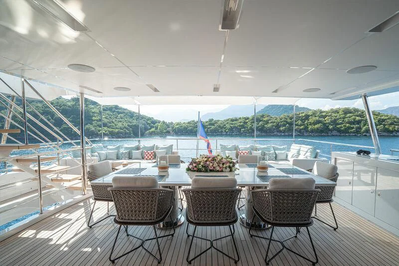 a table with chairs on it next to a pool aboard ELIZABETH Yacht for Sale