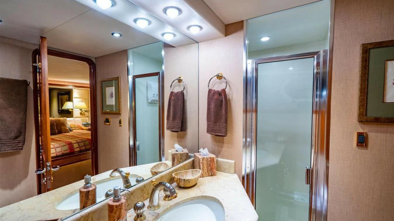 a bathroom with a large mirror aboard SNOWBORED Yacht for Sale
