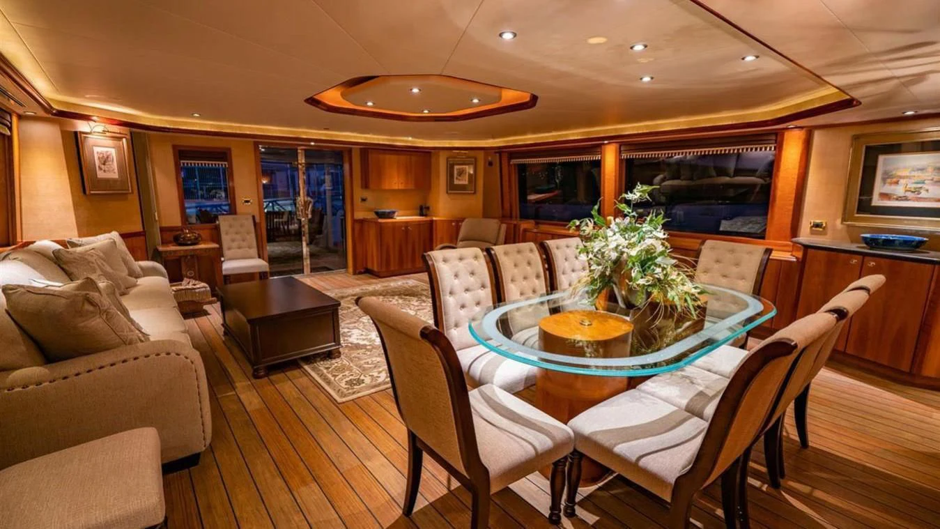 a living room with a table and chairs aboard SNOWBORED Yacht for Sale