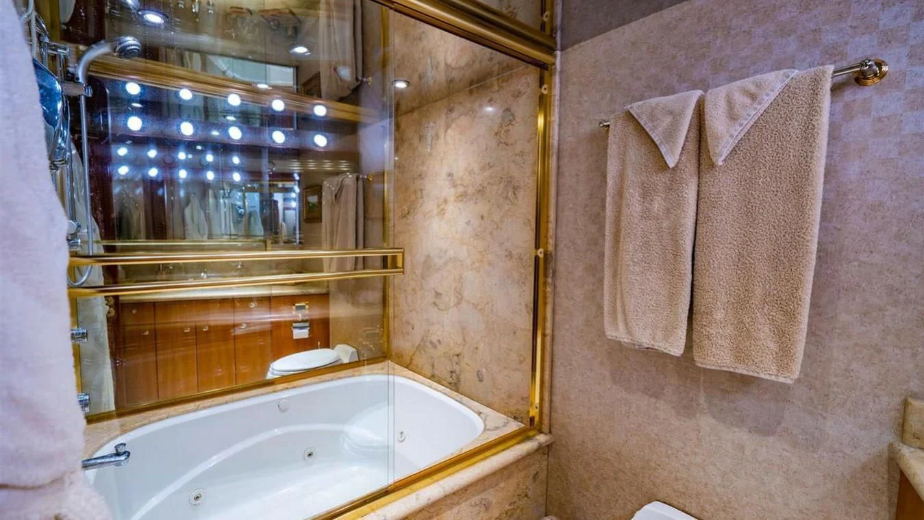 a bathroom with a large mirror aboard SNOWBORED Yacht for Sale