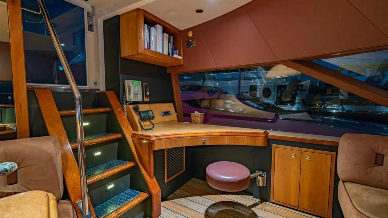 a bunk bed with a pink chair aboard SNOWBORED Yacht for Sale