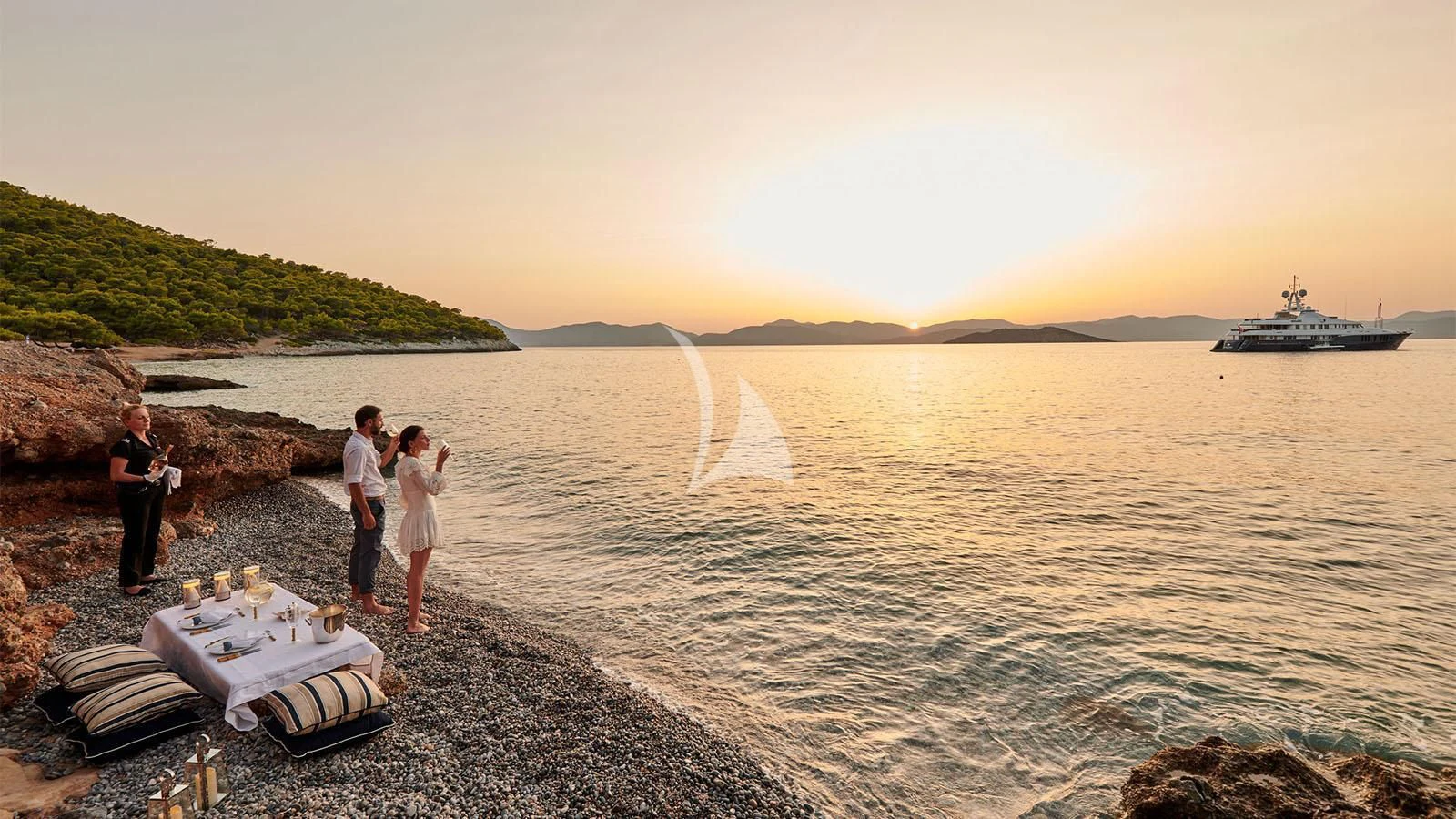 a group of people standing on a beach by a boat aboard RARE FIND Yacht for Charter