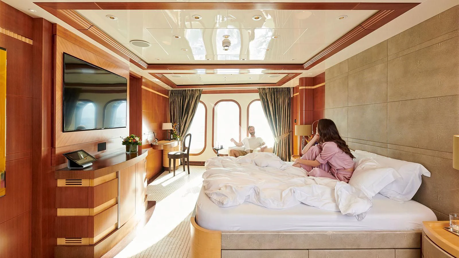 a person sitting on a bed aboard RARE FIND Yacht for Charter