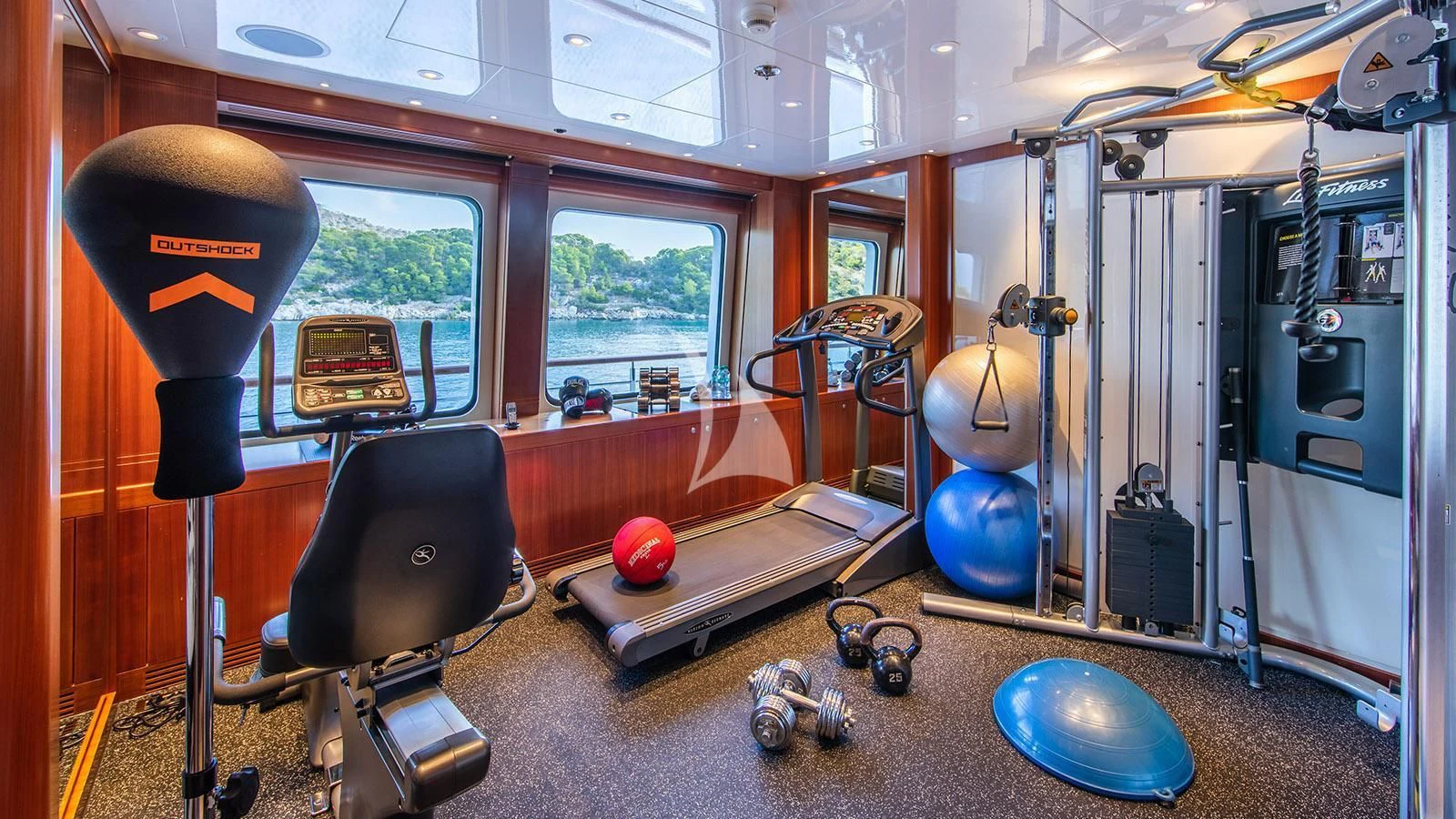 a room with a large mirror and a table with chairs and a ball aboard RARE FIND Yacht for Charter