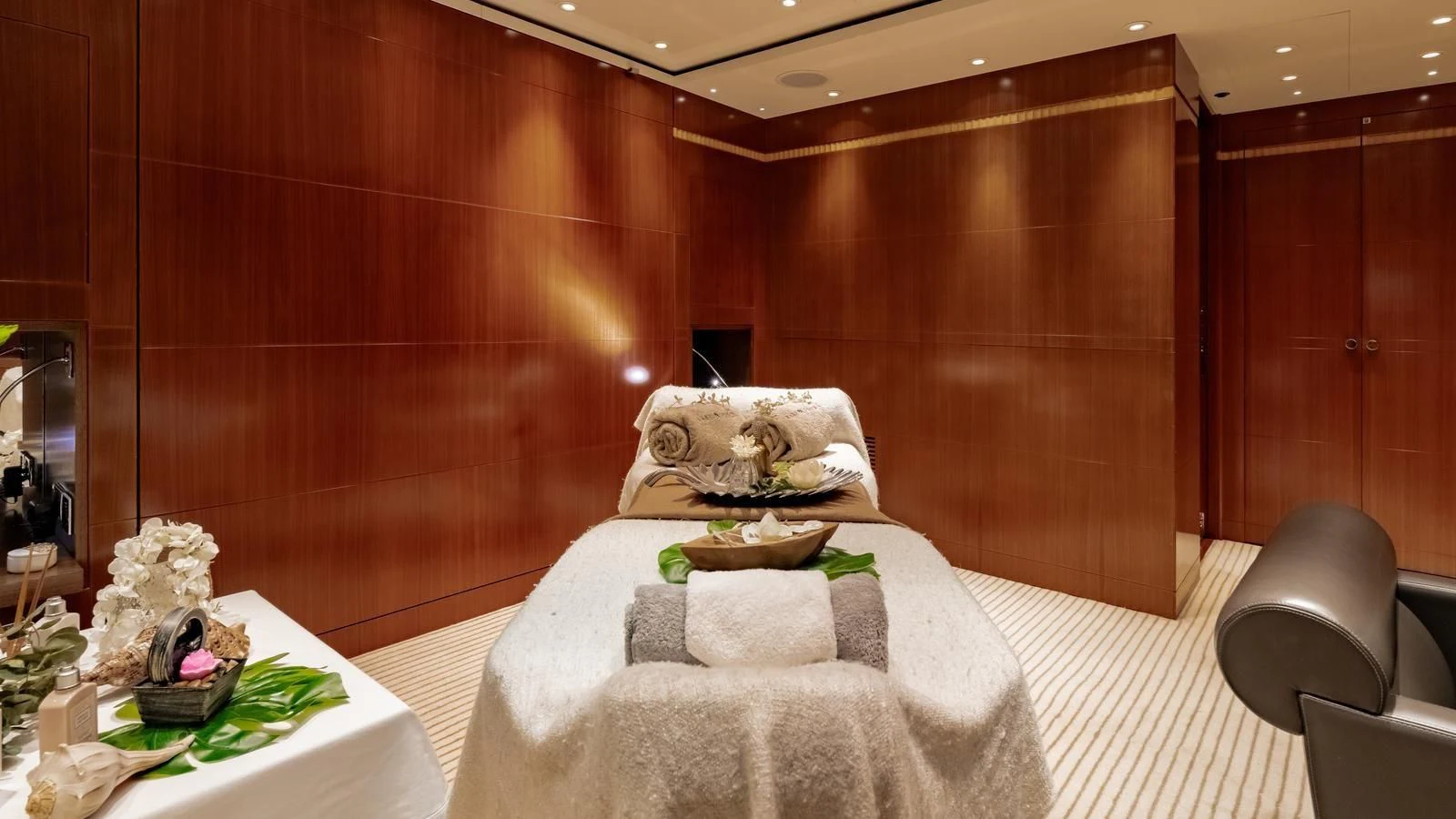 a bed with a table and chairs aboard RARE FIND Yacht for Charter