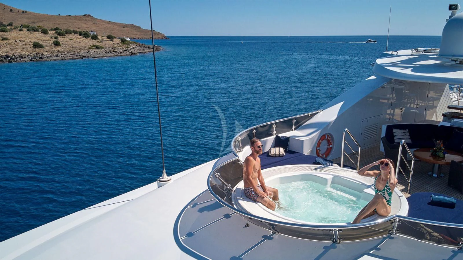 a man and woman sitting on a boat in the water aboard RARE FIND Yacht for Charter