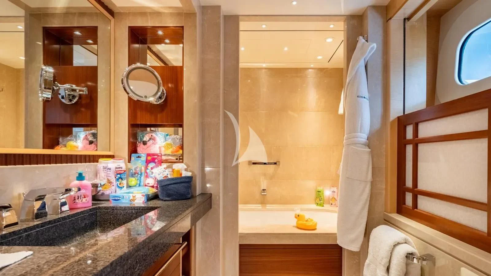 a bathroom with a sink and a mirror aboard RARE FIND Yacht for Charter