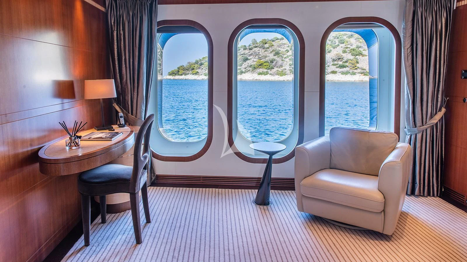 a room with a table chairs and a window aboard RARE FIND Yacht for Charter