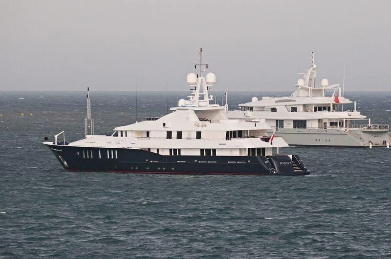 a couple of large white boats in the water aboard RARE FIND Yacht for Charter