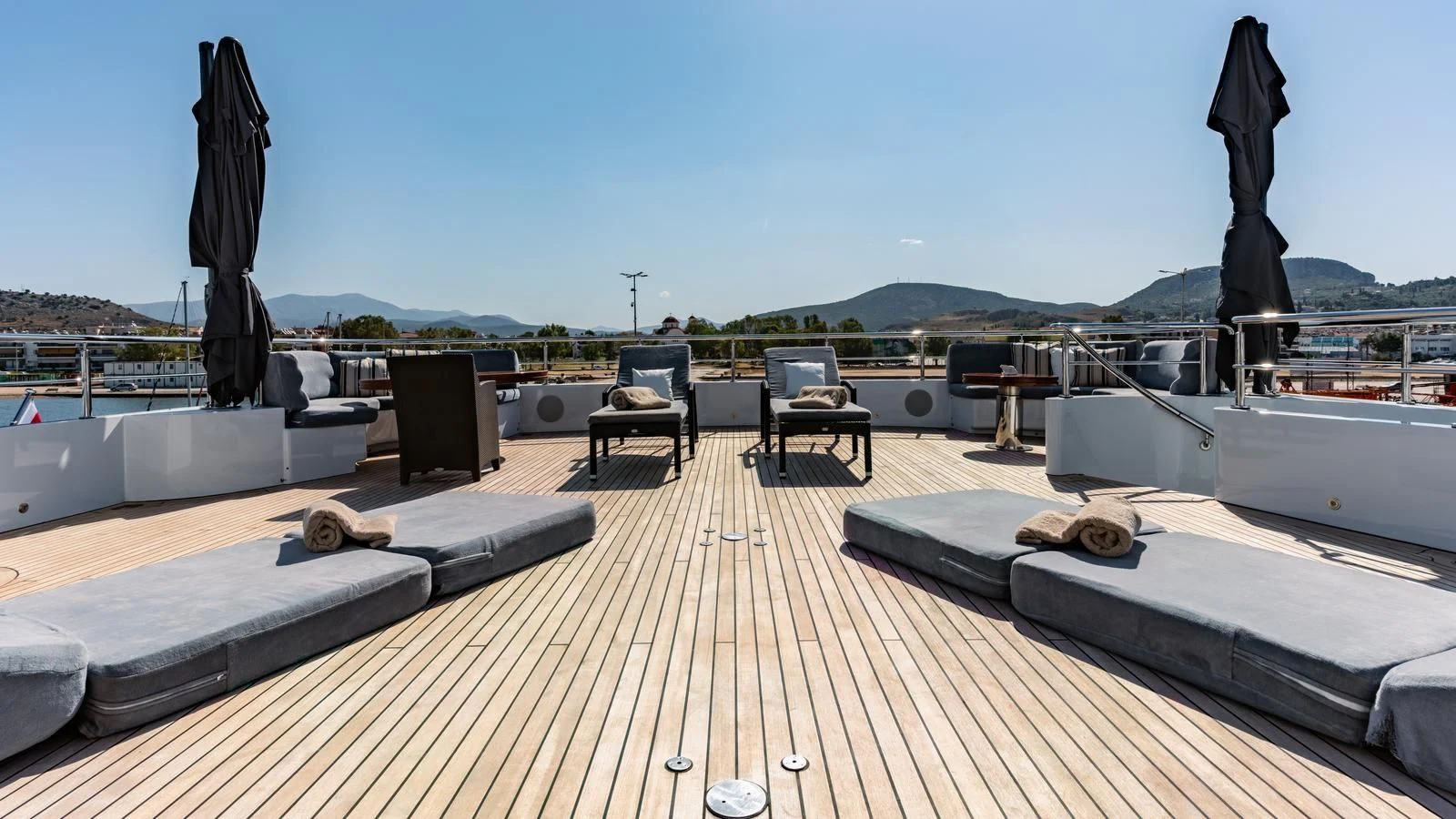a deck with chairs and a statue aboard RARE FIND Yacht for Charter