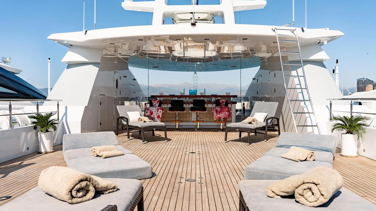 a large white yacht with a lounge area and a large patio with a large white building with a aboard RARE FIND Yacht for Charter